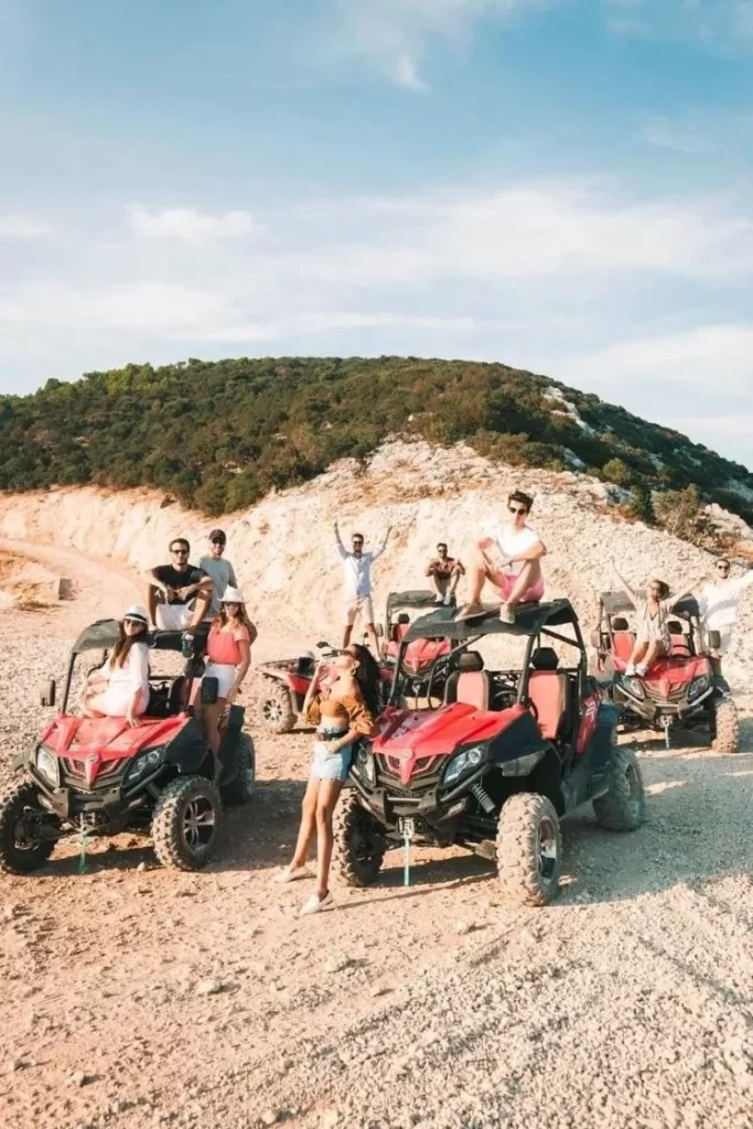 Guests posing with red buggies during a safari tour on the island of Brač